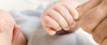 Baby holding father's pinky